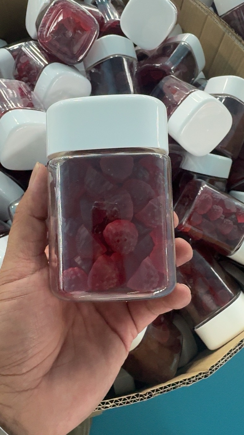 Bottled red gummies photographed in the NuCoreBio factory
