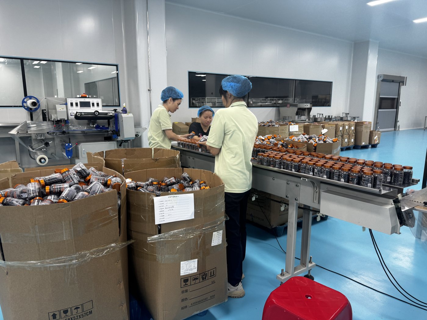 NuCoreBio team working on a finished supplement packaging line