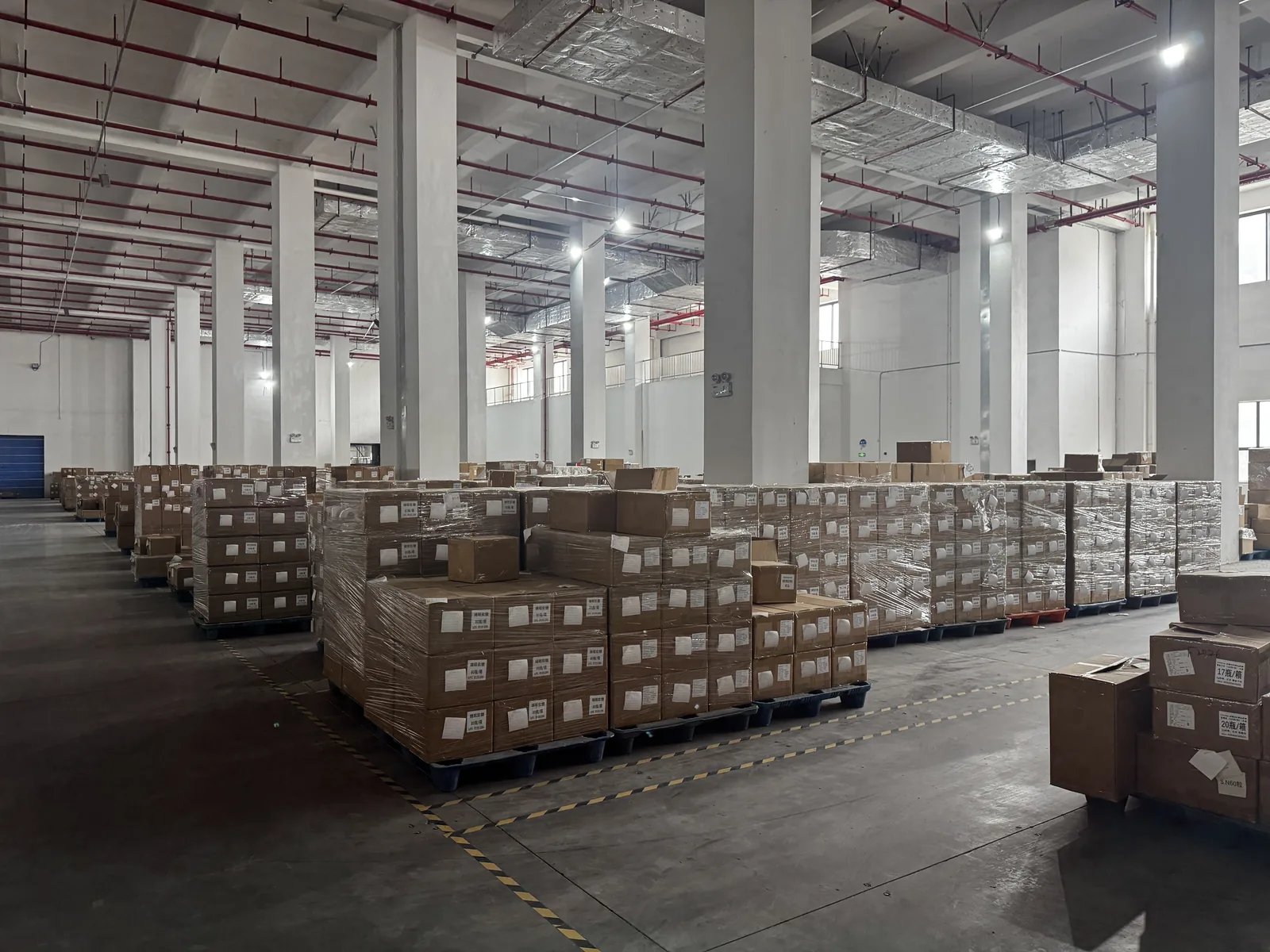 Finished private label supplement orders palletized for export in the NuCoreBio warehouse